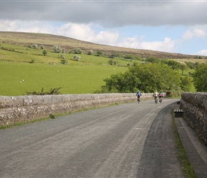 Cyclists enjoying late afternoon sun on the viaduct with Dartmoor to the left